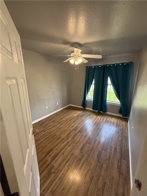 1204 Jim Mcvay, Siloam Springs, AR 72761 - unfurnished room featuring a ceiling fan, wood finished floors, and a textured ceiling