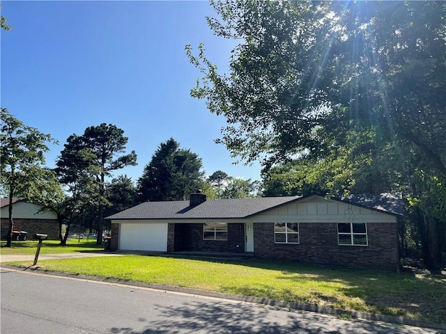 904 E Norristown Cir, Russellville, AR 72802 - single story home with a front yard, a garage, concrete driveway, and brick siding