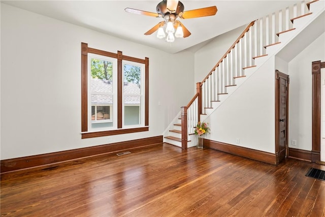 506 E Ashley St, Siloam Springs, AR 72761 - spare room with wood-type flooring, stairway, and ceiling fan
