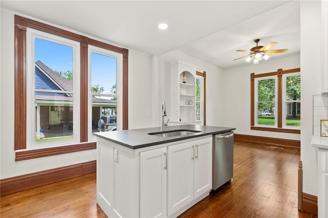 506 E Ashley St, Siloam Springs, AR 72761 - kitchen featuring stainless steel dishwasher, dark countertops, white cabinets, an island with sink, and dark wood-style flooring