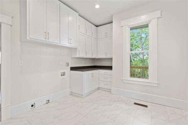 506 E Ashley St, Siloam Springs, AR 72761 - laundry area with cabinet space, light marble finish floors, hookup for an electric dryer, hookup for a washing machine, and recessed lighting