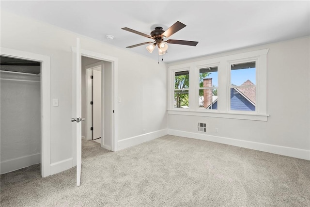 506 E Ashley St, Siloam Springs, AR 72761 - unfurnished bedroom with carpet flooring, a closet, and a ceiling fan
