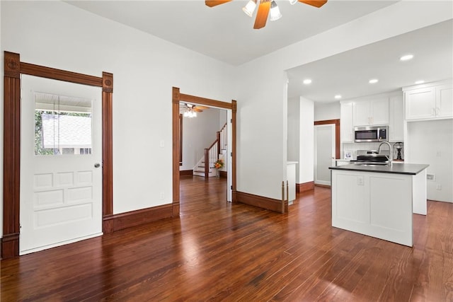 506 E Ashley St, Siloam Springs, AR 72761 - kitchen with a ceiling fan, stainless steel appliances, dark countertops, dark wood-style flooring, and recessed lighting