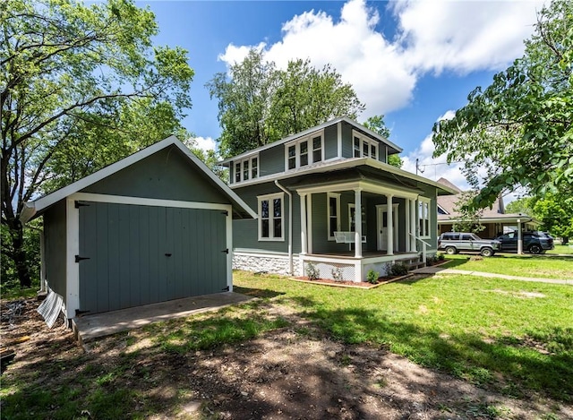 506 E Ashley St, Siloam Springs, AR 72761 - rear view of house with a porch, a lawn, and an outbuilding