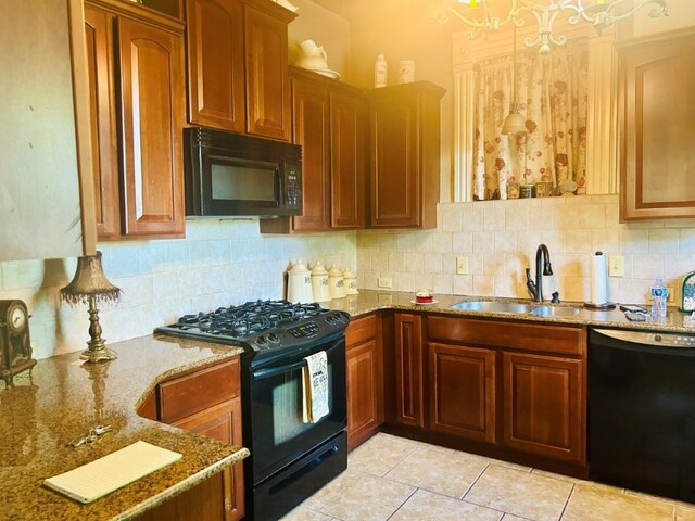1016 S 4th St, Rogers, AR 72756 - kitchen with black appliances, decorative backsplash, light stone counters, light tile patterned floors, and brown cabinets