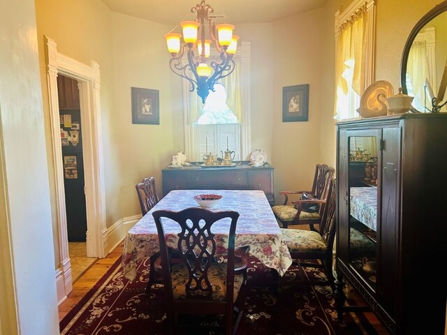 1016 S 4th St, Rogers, AR 72756 - dining room featuring a chandelier and wood finished floors