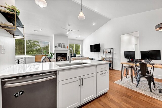 118 Briartown, Bentonville, AR 72712 - kitchen featuring dishwasher, open floor plan, a glass covered fireplace, ceiling fan, and vaulted ceiling