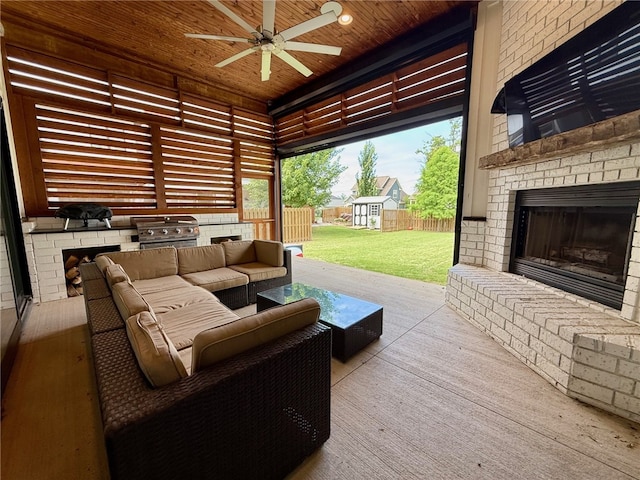 406 SW E St, Bentonville, AR 72712 - view of patio with exterior kitchen, a ceiling fan, an outdoor living space with a fireplace, and a storage unit