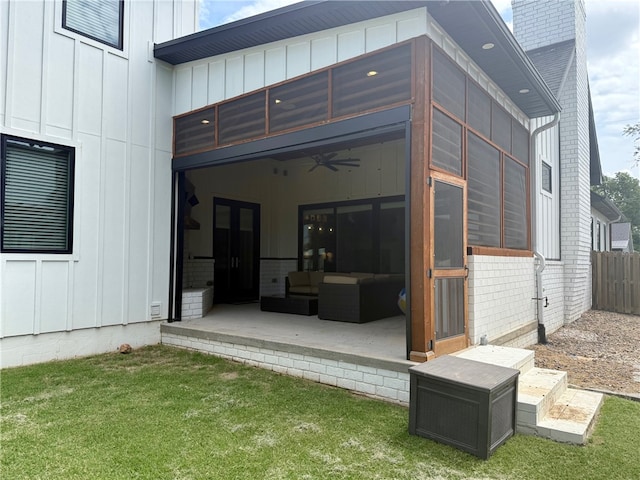 406 SW E St, Bentonville, AR 72712 - rear view of house featuring board and batten siding, ceiling fan, outdoor lounge area, a patio area, and a chimney