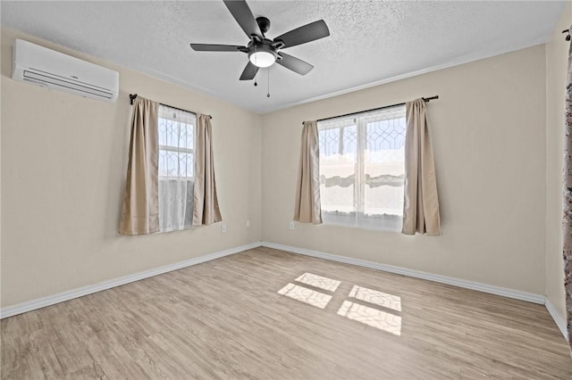142 N Maple St, Cave Springs, AR 72718 - empty room with a wall mounted AC, wood finished floors, a textured ceiling, and ceiling fan