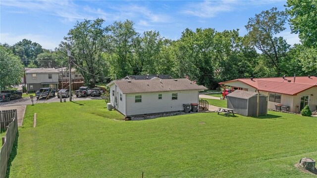 142 N Maple St, Cave Springs, AR 72718 - back of house featuring a shed and a lawn