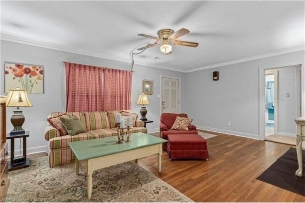 1107 S 20th St, Fort Smith, AR 72901 - living room featuring ceiling fan, wood finished floors, and crown molding