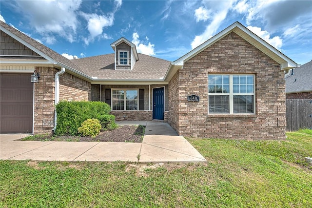 640 Spur Ln, Centerton, AR 72719 - view of front of home featuring roof with shingles, a garage, and brick siding