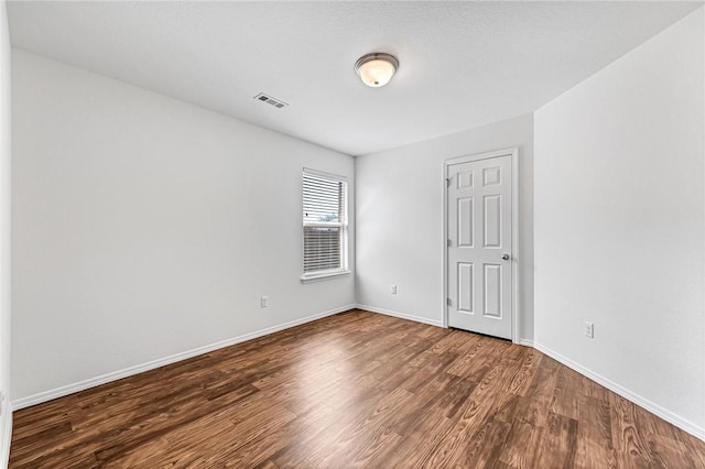 640 Spur Ln, Centerton, AR 72719 - spare room with dark wood finished floors and baseboards