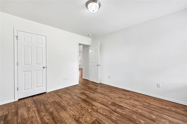 640 Spur Ln, Centerton, AR 72719 - unfurnished bedroom featuring wood finished floors and baseboards