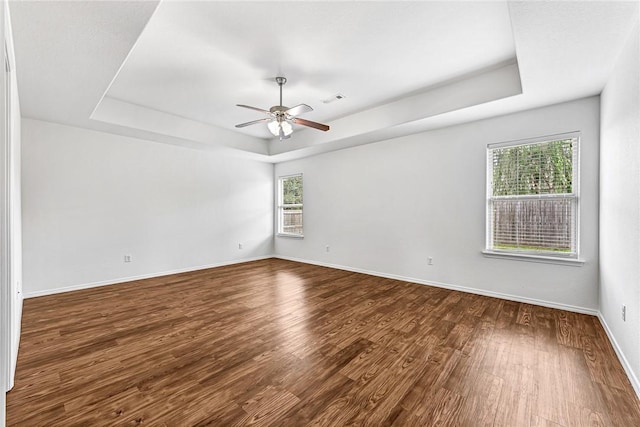 640 Spur Ln, Centerton, AR 72719 - spare room featuring a raised ceiling, wood finished floors, and ceiling fan
