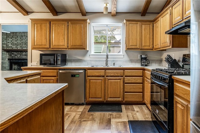 3310 Colton Dr, Springdale, AR 72762 - kitchen featuring black appliances, under cabinet range hood, beamed ceiling, light wood-type flooring, and light countertops