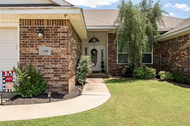 146 Horizon Ln, Alma, AR 72921 - entrance to property with brick siding, a garage, a lawn, and a shingled roof