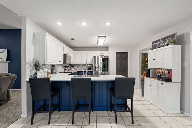 146 Horizon Ln, Alma, AR 72921 - kitchen with stainless steel fridge, a peninsula, tasteful backsplash, a kitchen bar, and recessed lighting