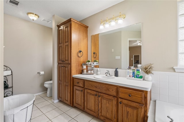 146 Horizon Ln, Alma, AR 72921 - bathroom featuring a soaking tub, vanity, tile patterned flooring, a ceiling fan, and a textured ceiling