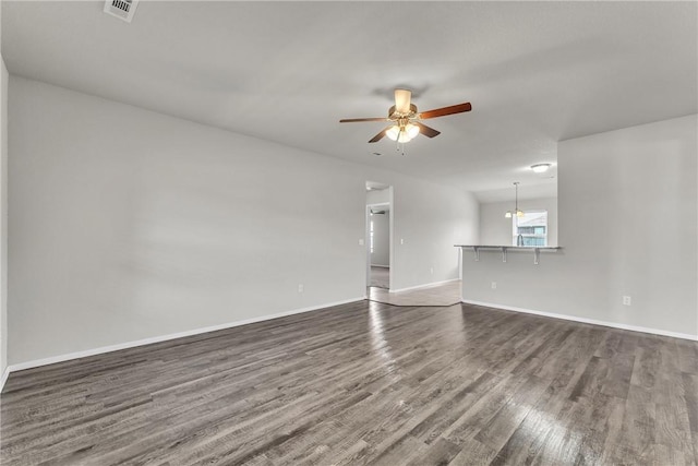 2304 Maplewood Dr, Lowell, AR 72745 - unfurnished living room with dark wood-type flooring and a ceiling fan