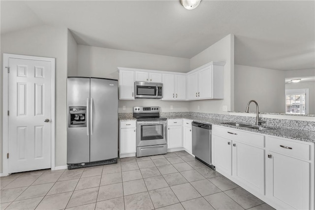 2304 Maplewood Dr, Lowell, AR 72745 - kitchen with appliances with stainless steel finishes, light stone counters, white cabinets, light tile patterned floors, and vaulted ceiling