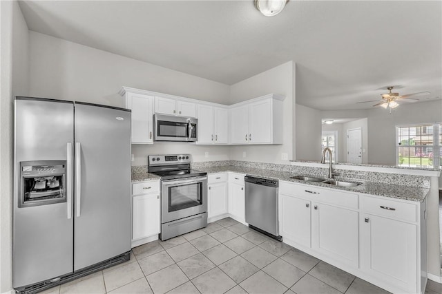 2304 Maplewood Dr, Lowell, AR 72745 - kitchen with appliances with stainless steel finishes, white cabinetry, light stone counters, a peninsula, and a ceiling fan