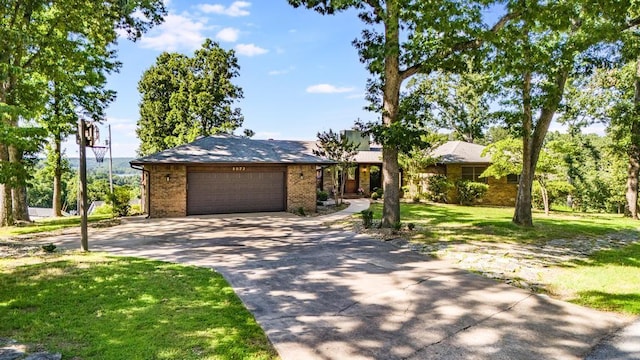 8073 Old White River Rd, Rogers, AR 72756 - view of front facade featuring concrete driveway, an attached garage, brick siding, and a front lawn