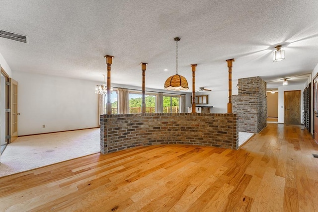 8073 Old White River Rd, Rogers, AR 72756 - unfurnished living room with light wood finished floors and a textured ceiling
