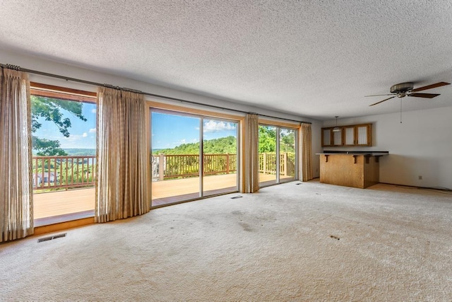 8073 Old White River Rd, Rogers, AR 72756 - unfurnished living room featuring a ceiling fan, carpet floors, and a textured ceiling