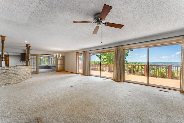 8073 Old White River Rd, Rogers, AR 72756 - unfurnished living room with a chandelier, carpet floors, ceiling fan, and a textured ceiling