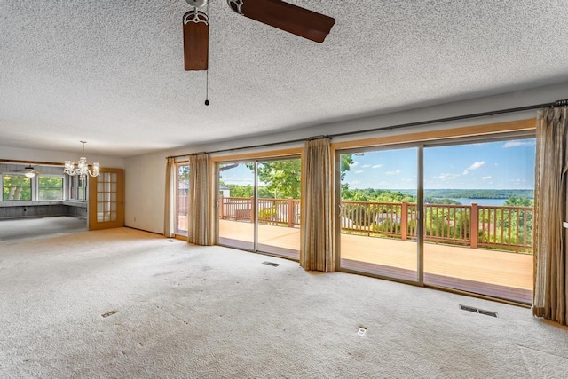 8073 Old White River Rd, Rogers, AR 72756 - unfurnished living room featuring a chandelier, carpet floors, healthy amount of natural light, and a textured ceiling
