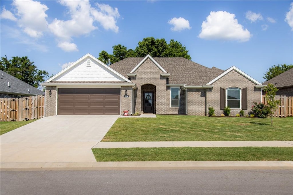 304 W Tyler Rd, Farmington, AR 72730 - view of front facade with brick siding, an attached garage, and driveway