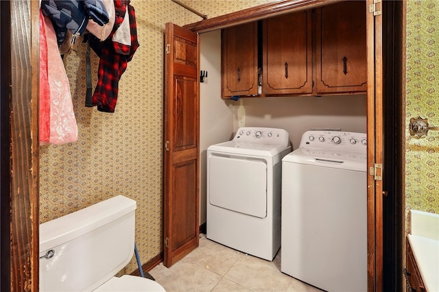 614 Beaconsfield Rd, Sherwood, AR 72120 - washroom featuring washing machine and dryer, wallpapered walls, light tile patterned floors, and cabinet space