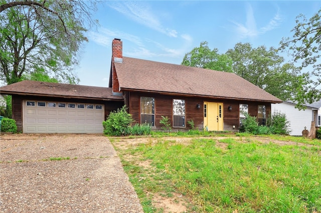 614 Beaconsfield Rd, Sherwood, AR 72120 - view of front of house with driveway, a garage, and a chimney