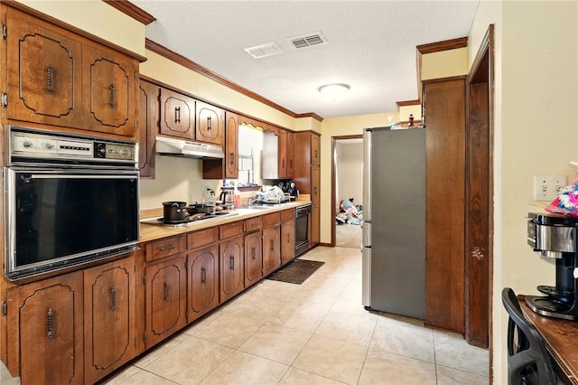 614 Beaconsfield Rd, Sherwood, AR 72120 - kitchen featuring oven, freestanding refrigerator, under cabinet range hood, dishwasher, and cooktop