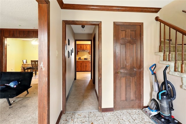 614 Beaconsfield Rd, Sherwood, AR 72120 - corridor featuring ornamental molding, stairs, and light tile patterned floors