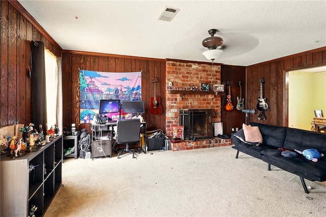 614 Beaconsfield Rd, Sherwood, AR 72120 - carpeted living area with wood walls, an office area, a fireplace, a ceiling fan, and crown molding