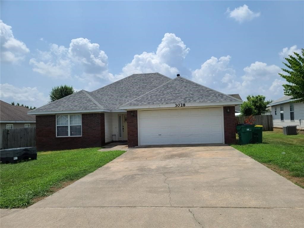 3028 Orchard St, Springdale, AR 72764 - ranch-style house featuring brick siding, concrete driveway, and roof with shingles