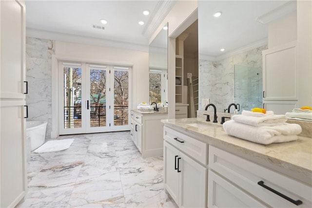 837-839 N Gregg Ave, Fayetteville, AR 72701 - bathroom featuring crown molding, marble finish flooring, two vanities, a marble finish shower, and a freestanding tub