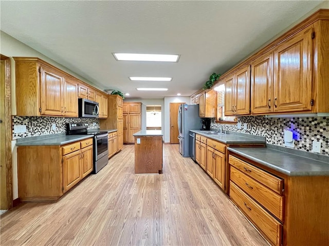 6 Hillcrest Dr, Holiday Island, AR 72631 - kitchen featuring stainless steel appliances, light wood-style floors, backsplash, a center island, and brown cabinets