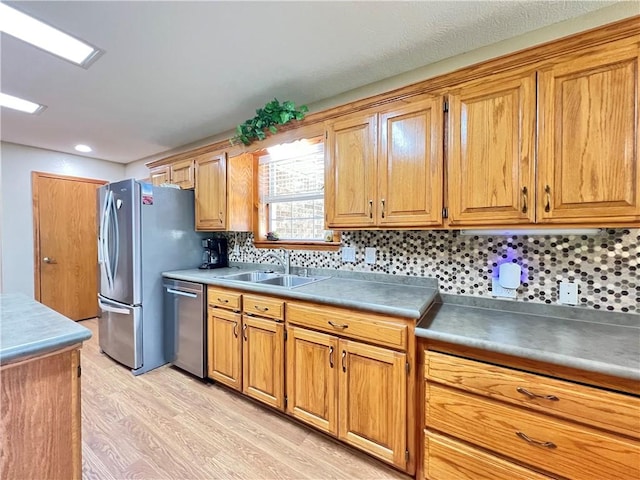 6 Hillcrest Dr, Holiday Island, AR 72631 - kitchen featuring stainless steel dishwasher, light wood finished floors, tasteful backsplash, and brown cabinetry