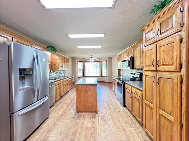 6 Hillcrest Dr, Holiday Island, AR 72631 - kitchen with stainless steel appliances, a kitchen island, light wood-type flooring, tasteful backsplash, and brown cabinetry
