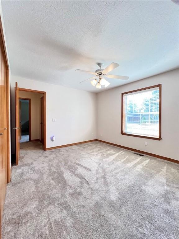 6 Hillcrest Dr, Holiday Island, AR 72631 - spare room featuring carpet, ceiling fan, and a textured ceiling