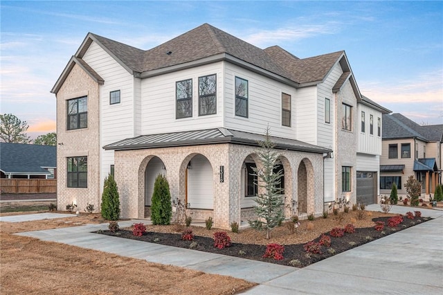 1316 Bella Vista Rd, Bentonville, AR 72712 - view of front of house featuring covered porch, a standing seam roof, brick siding, and a metal roof