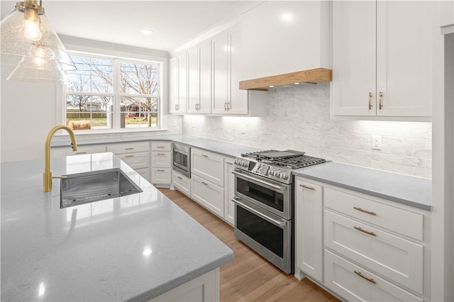 1316 Bella Vista Rd, Bentonville, AR 72712 - kitchen featuring appliances with stainless steel finishes, white cabinetry, and light wood-type flooring
