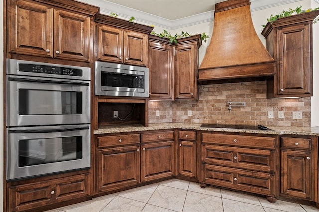 3321 E Cadberry Ter, Fayetteville, AR 72701 - kitchen featuring stainless steel appliances, custom range hood, decorative backsplash, light stone counters, and ornamental molding