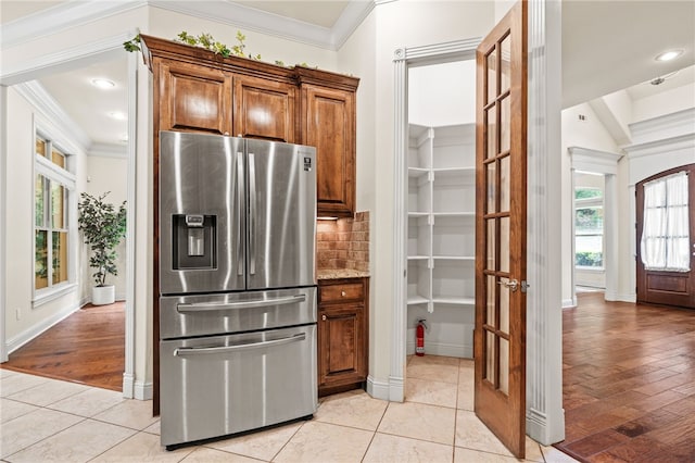 3321 E Cadberry Ter, Fayetteville, AR 72701 - kitchen with stainless steel refrigerator with ice dispenser, ornamental molding, plenty of natural light, tasteful backsplash, and brown cabinetry