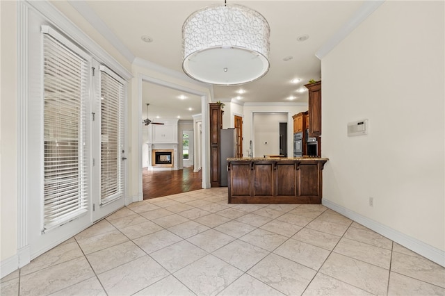 3321 E Cadberry Ter, Fayetteville, AR 72701 - kitchen featuring a peninsula, light tile patterned floors, ornamental molding, appliances with stainless steel finishes, and ceiling fan