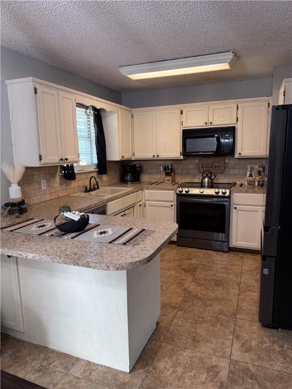 604 W Carver St, Ozark, AR 72949 - kitchen with black appliances, a peninsula, tasteful backsplash, white cabinetry, and a textured ceiling